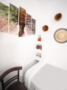a room with five paintings on the wall at stamatia's rooms in Agios Kirykos