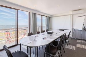 a meeting room with a long table and chairs at Best Western Hôtel Royan Océan in Royan