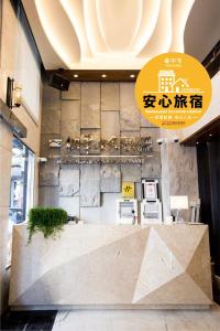 a lobby with a reception desk in a building at Hotel Maple Taiwan Boulevard in Taichung