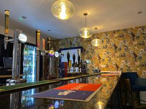 a bar in a pub with colorful wallpaper at Luxury Holiday Home in Anderby Creek in Anderby