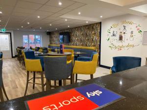 a restaurant with tables and chairs and a chalk board at Luxury Holiday Home in Anderby Creek in Anderby