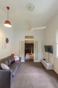 a living room with a couch and a bed at Grimshaw House in Cairns