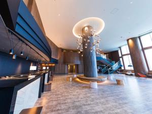 a lobby with a large chandelier in a building at Okinawa Grand Mer Resort in Okinawa City