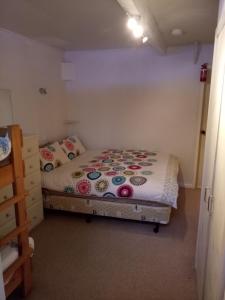 a small bedroom with a bed in a room at Shamrock Apartment 5 in Mount Hotham
