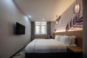 Postel nebo postele na pokoji v ubytování Guangzhou Homies Hotel