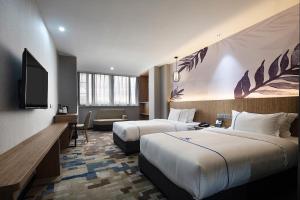 TV a/nebo společenská místnost v ubytování Guangzhou Homies Hotel