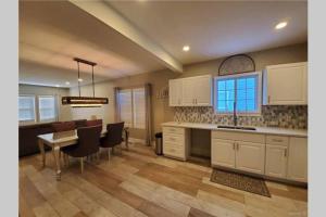 a kitchen and dining room with a table and chairs at Luxury Private Home in the Heart of Niagara Falls in Niagara Falls