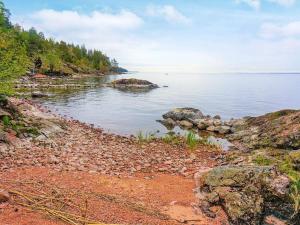 a rocky shoreline with trees and a body of water at 2 person holiday home in FR NDEFORS in Frändefors