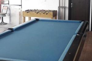 a pool table in the middle of a room at RedDoorz Plus @ Doorman Guest House in Bandung