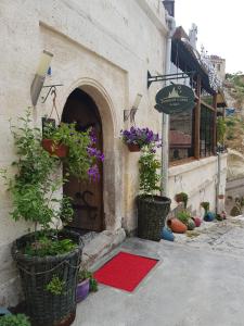 an entrance to a building with potted plants and a door at Demisos Caves Hotel in Urgup