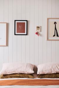a bedroom with two beds and two pictures on the wall at Anchor Geelong in Geelong