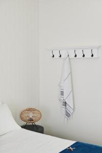 a white bedroom with a bed and a table at Anchor Geelong in Geelong