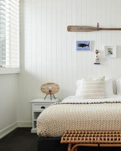 a bedroom with a bed and a rattan chair at Anchor Geelong in Geelong