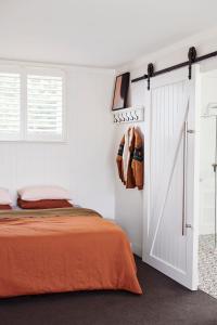 a bedroom with a bed and a sliding door at Anchor Geelong in Geelong