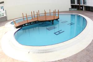 a swimming pool with a bench in a building at Grand Amisos Hotel in Samsun