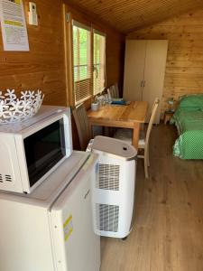 a kitchen with a microwave and a table in a cabin at Ubytovani U lišáka FOXE in Bulhary +25 photos