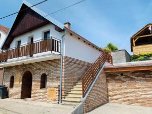 a brick house with a staircase on it at Ubytovani U lišáka FOXE in Bulhary