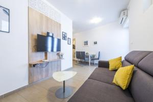 a living room with a couch and a table at Tinker Bell Apartment in Dubrovnik