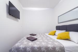 a bedroom with a bed and a flat screen tv at Tinker Bell Apartment in Dubrovnik