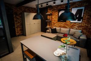 a living room with a couch and a table at Apartament Piastowska No.6 in Olsztyn