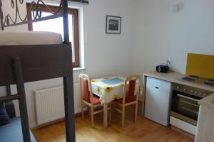 a small kitchen with a table and chairs in a room at Apartma Lovor in Bohinj
