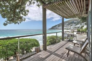 a wooden deck with a view of the ocean at Wixy in Cape Town