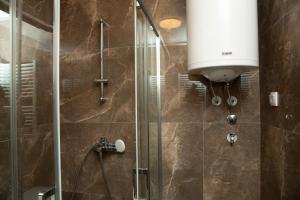 a bathroom with a shower with a glass door at Novi Pazar APARTMAN LUX 2 in Novi Pazar +54 photos