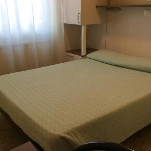 Säng eller sängar i ett rum på Hotel Del Golfo