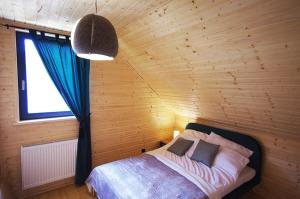 a bedroom with a bed in a wooden room at Michałówka Zawoja in Zawoja