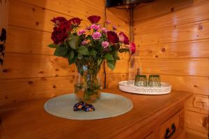 a vase of flowers sitting on top of a table at Leśniczówka Przytulia - Bieszczadzka Zagroda in Lesko +87 photos