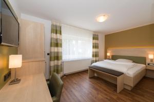 Postel nebo postele na pokoji v ubytování Hotel SCHNEIDER