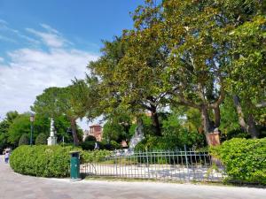a fence in front of a park with trees at BIENNALE APARTMENT NEAR SAN MARCO in Venice