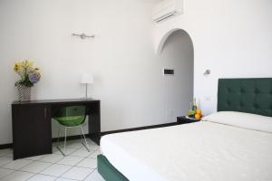 A bed or beds in a room at La Zagara Hotel