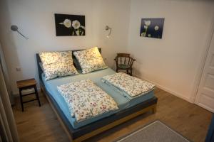 a bed with two pillows on it in a room at Ferienwohnung _Altes Zollamt_ in Neustadt in Holstein