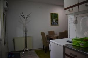 a kitchen with a counter and a table with chairs at Dobrila Apartments in Zlatibor