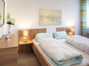 a bedroom with two beds and a desk at Traumferienhaus XXL Ortner in Wetzendorf