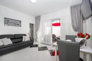 a living room with a couch and a table at Villa Inis in Makarska