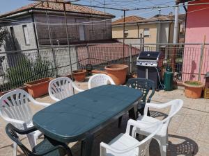 a table and chairs and a grill on a patio at Ca' Dorotea in Canaro