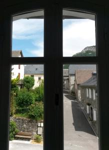 an open window with a view of a street at Maison Bergoun in Borce +55 photos