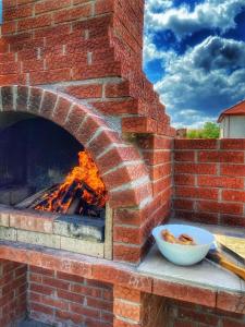 a brick oven with a bowl of food in it at Casa cu Flori in 2 Mai