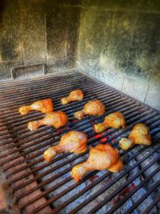 a group of chickens cooking on a grill at Casa cu Flori in 2 Mai