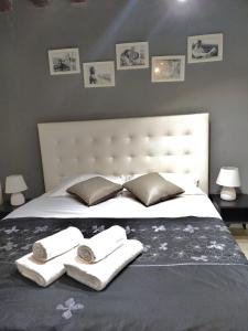 a bed with two towels and two pillows on it at BIENNALE APARTMENT NEAR SAN MARCO in Venice
