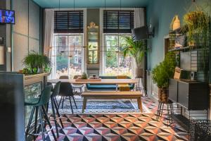 a dining room with a table and chairs at Hotel Alexander in Amsterdam +51 photos