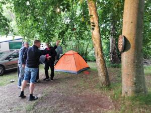 un groupe de personnes debout à côté d'une tente dans l'établissement Frederiksværk Camping & Hostel, à Frederiksværk