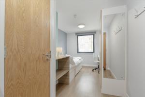 a room with a wooden floor and a white wall at ALTIDO Affordable Edinburgh in Edinburgh