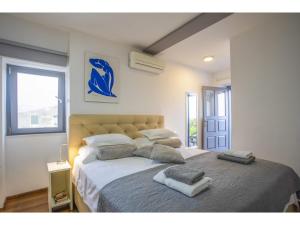 a bedroom with a large bed with towels on it at Palace Tower View in Split