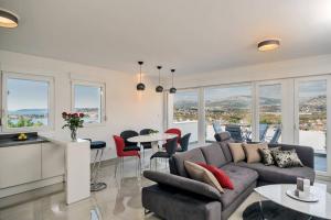 a living room with a couch and a table with chairs at Villa Graf in Podstrana
