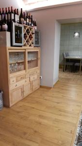 a room with a wooden cabinet filled with wine bottles at Cal Duran in Esparraguera