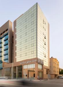 a building with a sign on the front of it at Seiba Hotel Apartments-Riyadh in Riyadh