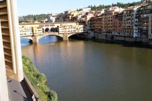 a bridge over a river in a city with buildings at PINI in Florence